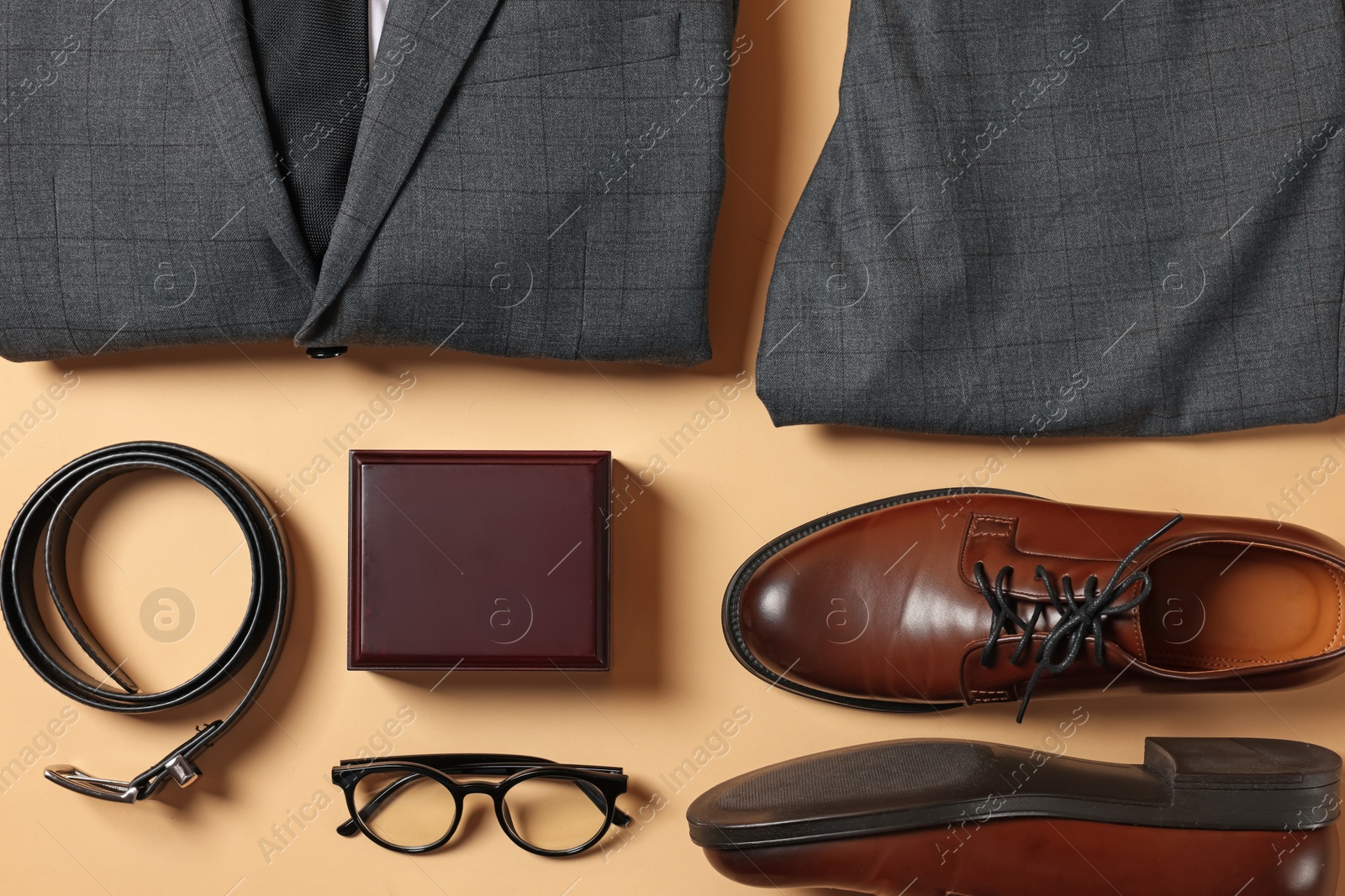 Photo of Elegant men's outfit. Stylish suit, accessories and shoes on beige background, flat lay