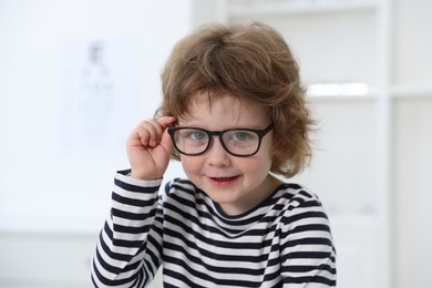 Little boy wearing glasses at ophthalmologist office