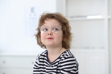 Little boy wearing glasses at ophthalmologist office