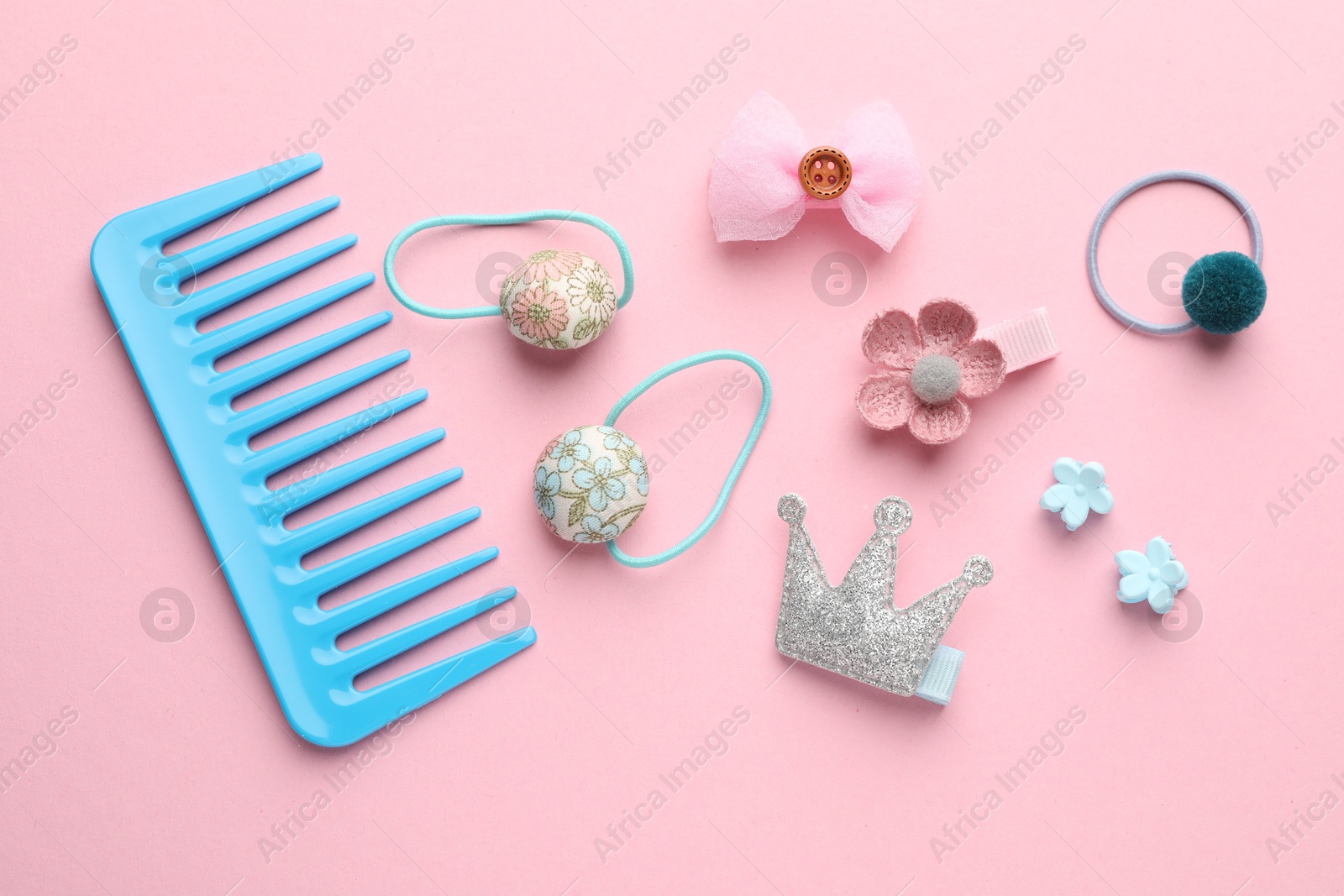 Photo of Different hair accessories on pink background, flat lay