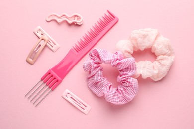 Photo of Different hair accessories on pink background, flat lay