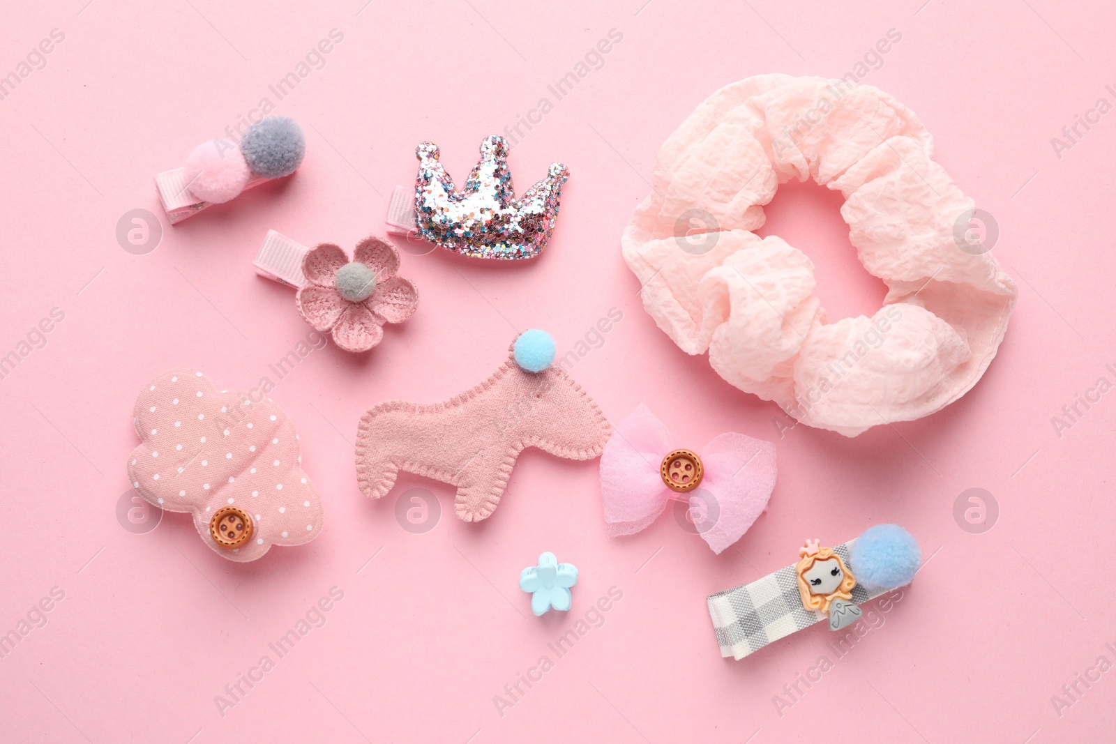 Photo of Different hair accessories on pink background, flat lay