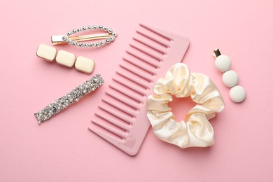 Photo of Different hair accessories on pink background, flat lay