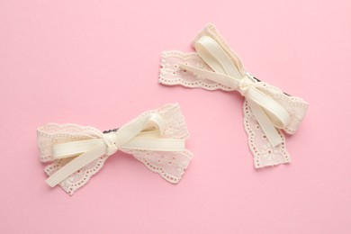 Beautiful hair bows on pink background, flat lay