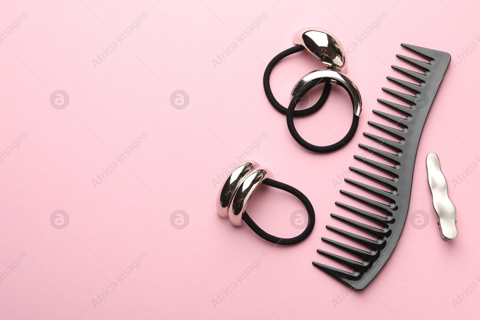 Photo of Different hair accessories on pink background, flat lay. Space for text