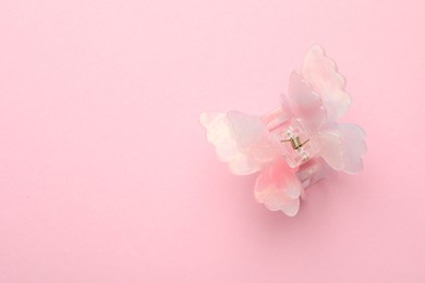 Photo of Beautiful hair clip on pink background, top view. Space for text