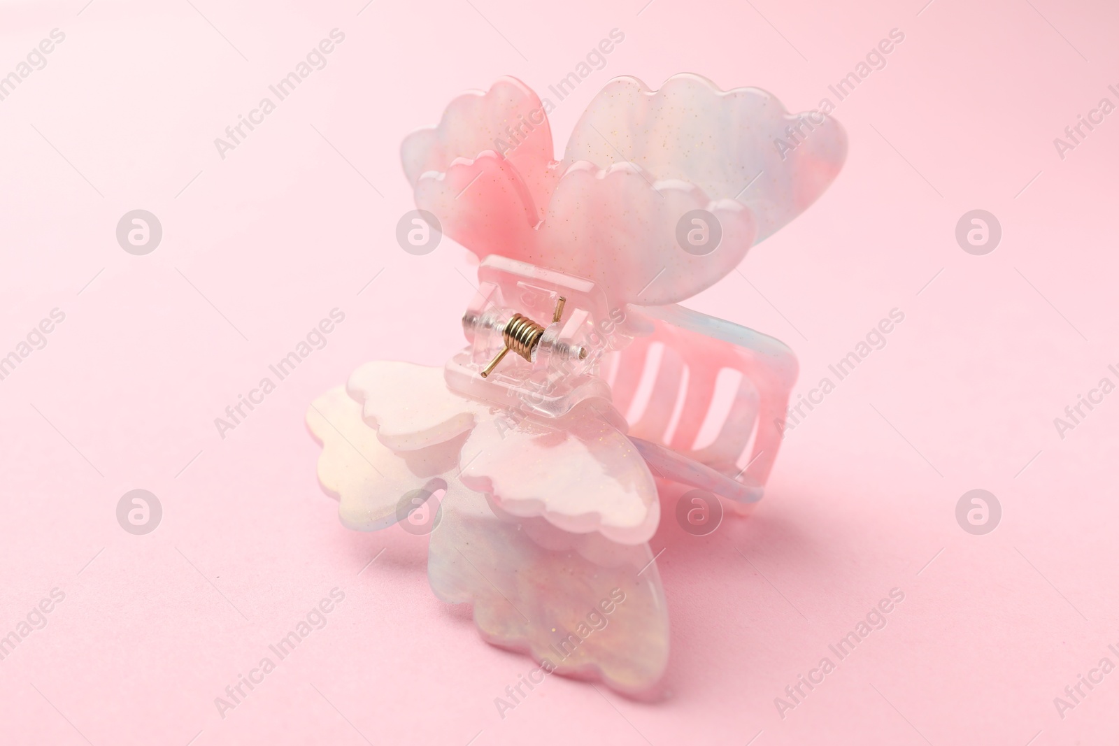 Photo of Beautiful hair clip on pink background, closeup