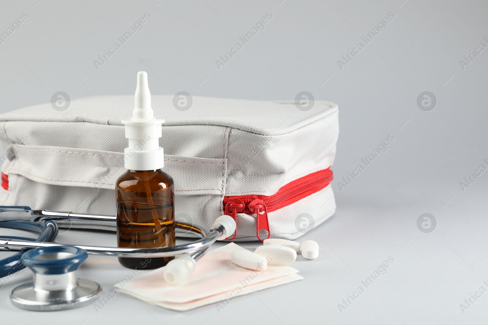 First aid kit. Different medical supplies on light grey background, closeup. Space for text Photo of First aid kit. Different medical supplies on light grey background, closeup. Space for text