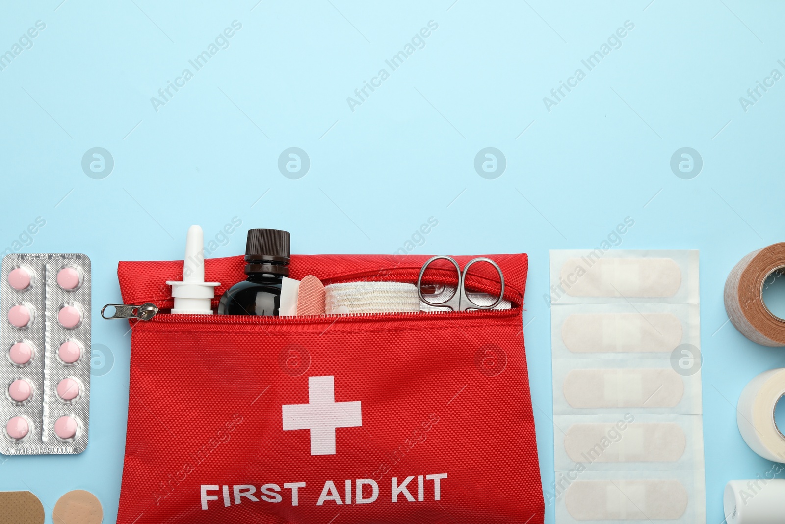 First aid kit. Different medical supplies on light blue background, flat lay. Space for text Photo of First aid kit. Different medical supplies on light blue background, flat lay. Space for text