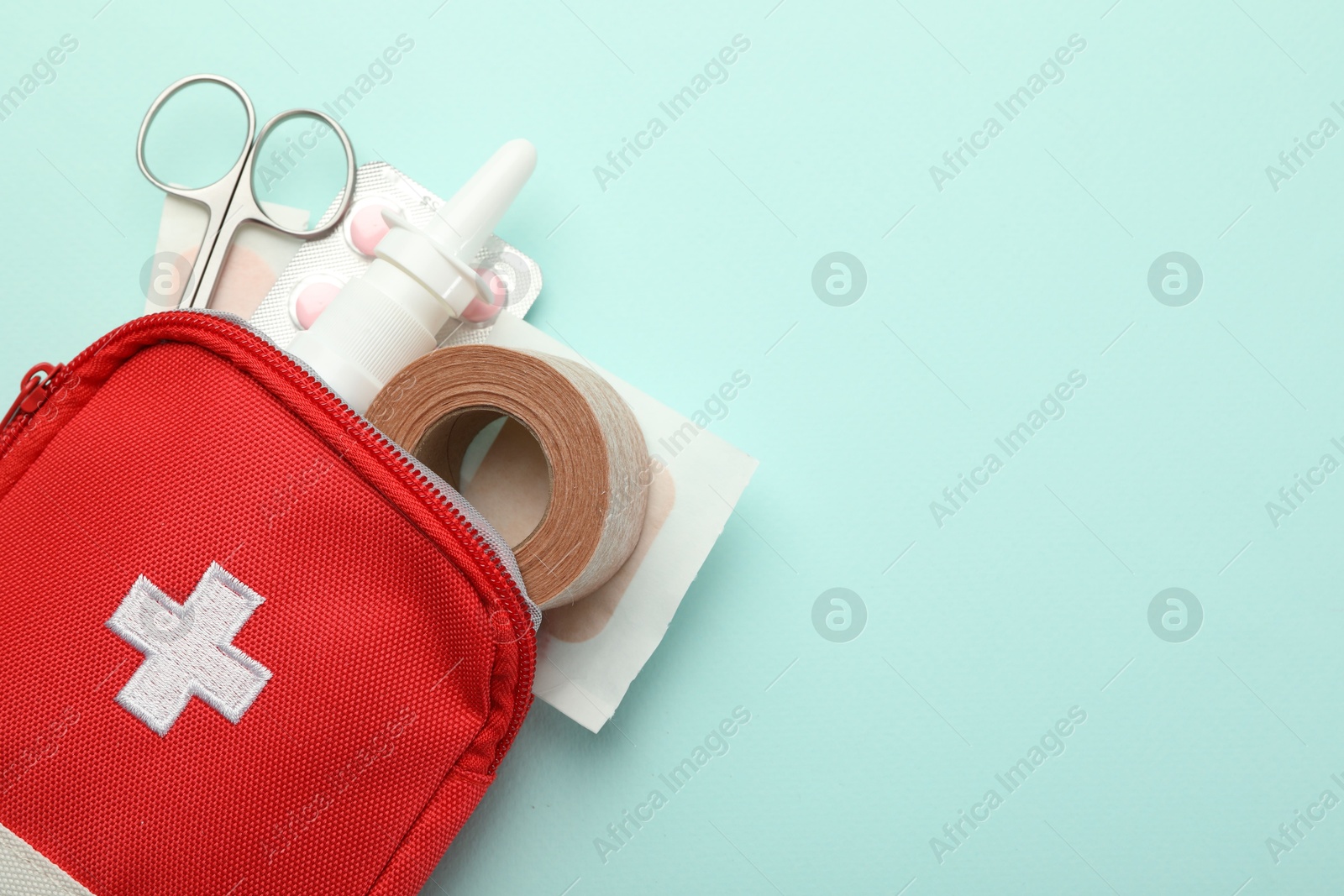 First aid kit. Different medical supplies on light blue background, top view. Space for text Photo of First aid kit. Different medical supplies on light blue background, top view. Space for text