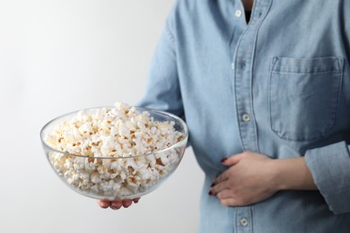 Photo of Woman refusing to eat popcorn on white background, closeup. Food allergy concept