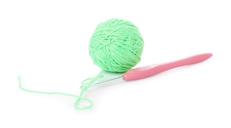 Ball of light green yarn and crochet hook isolated on white