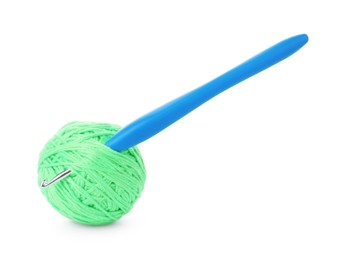 Ball of light green yarn and crochet hook isolated on white