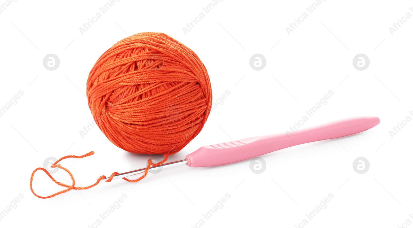 Photo of Ball of orange yarn and crochet hook isolated on white