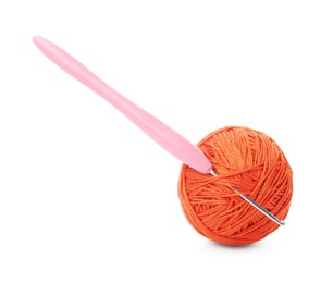 Ball of orange yarn and crochet hook isolated on white