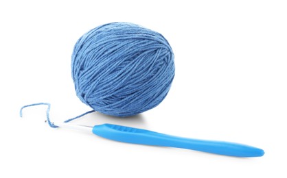 Photo of Ball of blue yarn and hook isolated on white