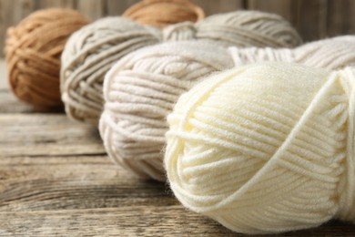 Skeins of yarn on wooden table, closeup