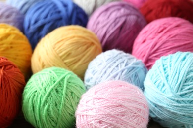 Photo of Balls of colorful yarn as background, closeup