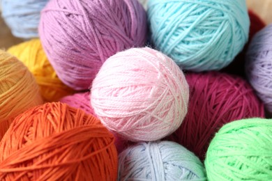 Photo of Balls of colorful yarn as background, top view