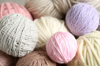 Photo of Many balls of colorful yarn on table, closeup