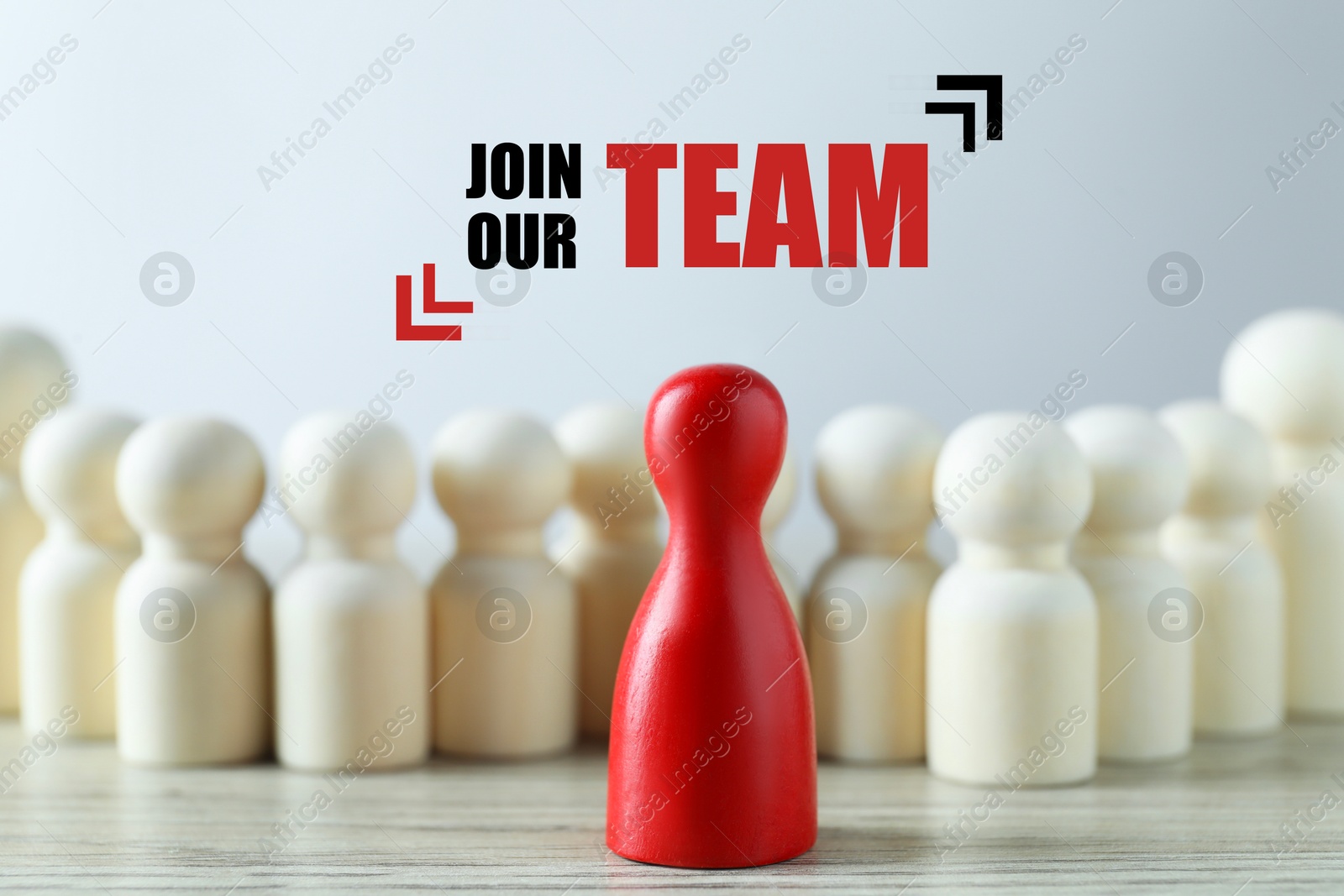 Image of Join Our Team announcement. Red figure among white ones on table. Human resource