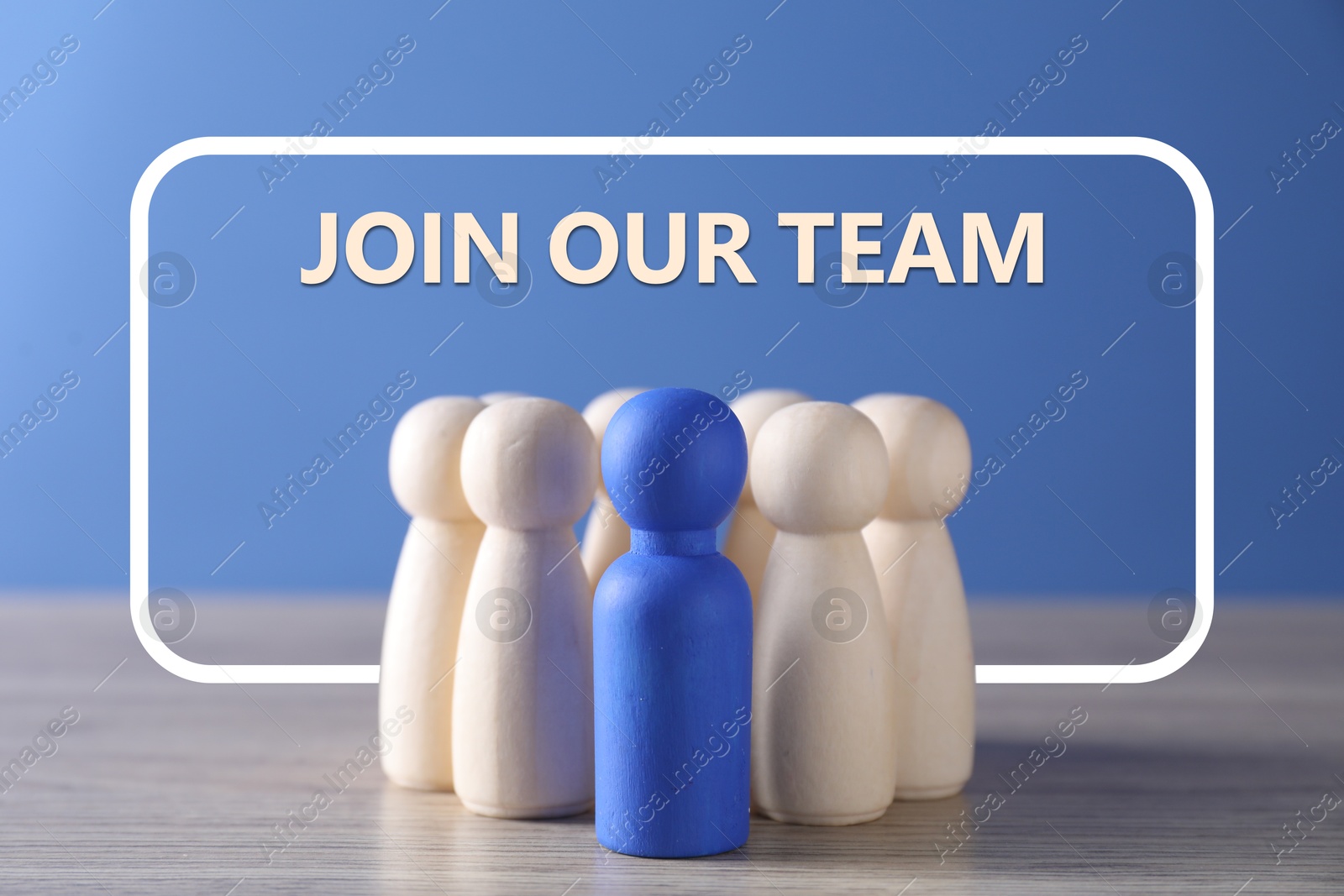 Image of Join Our Team announcement. Blue figure among wooden ones on table. Human resource