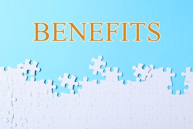 Image of Benefits word and white jigsaw puzzle pieces on light blue background, top view