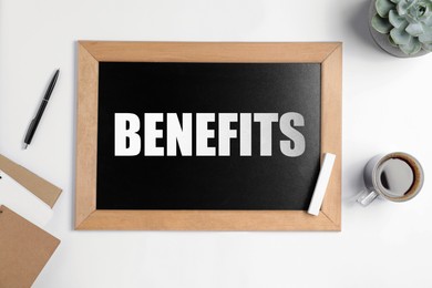 Image of Small chalkboard with word Benefits, coffee, pen, notebooks and plant on white background, top view