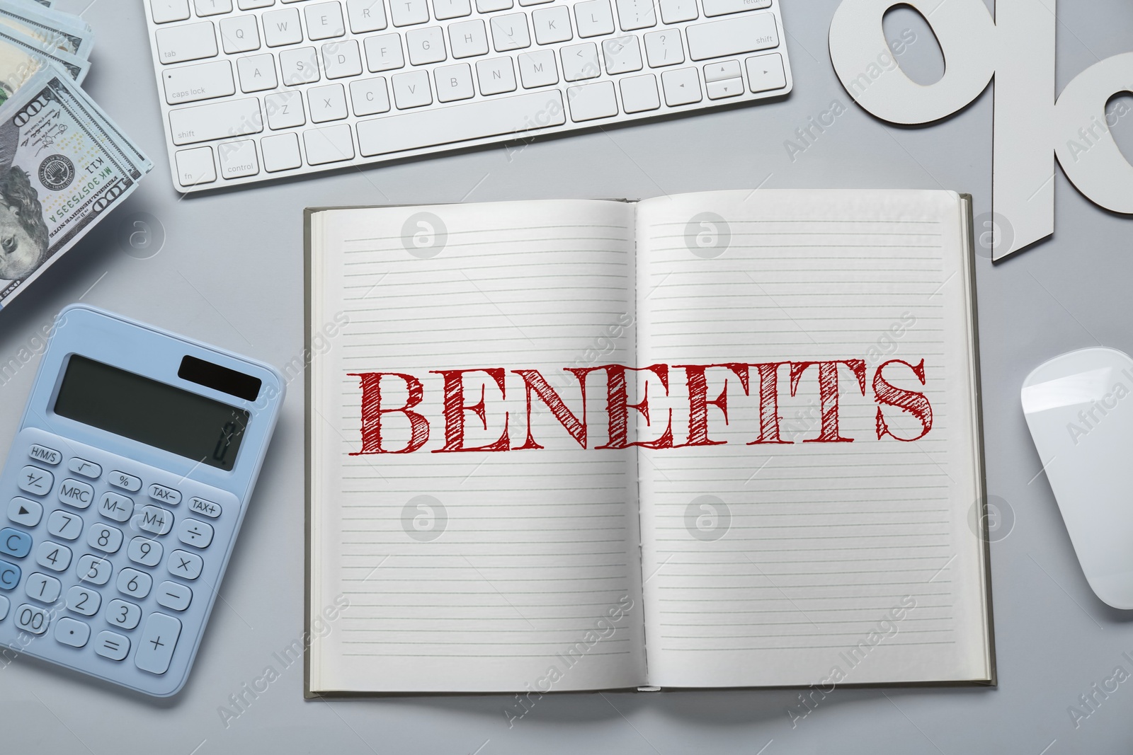 Image of Benefits word in notebook, calculator, money, computer keyboard and mouse on grey table, top view