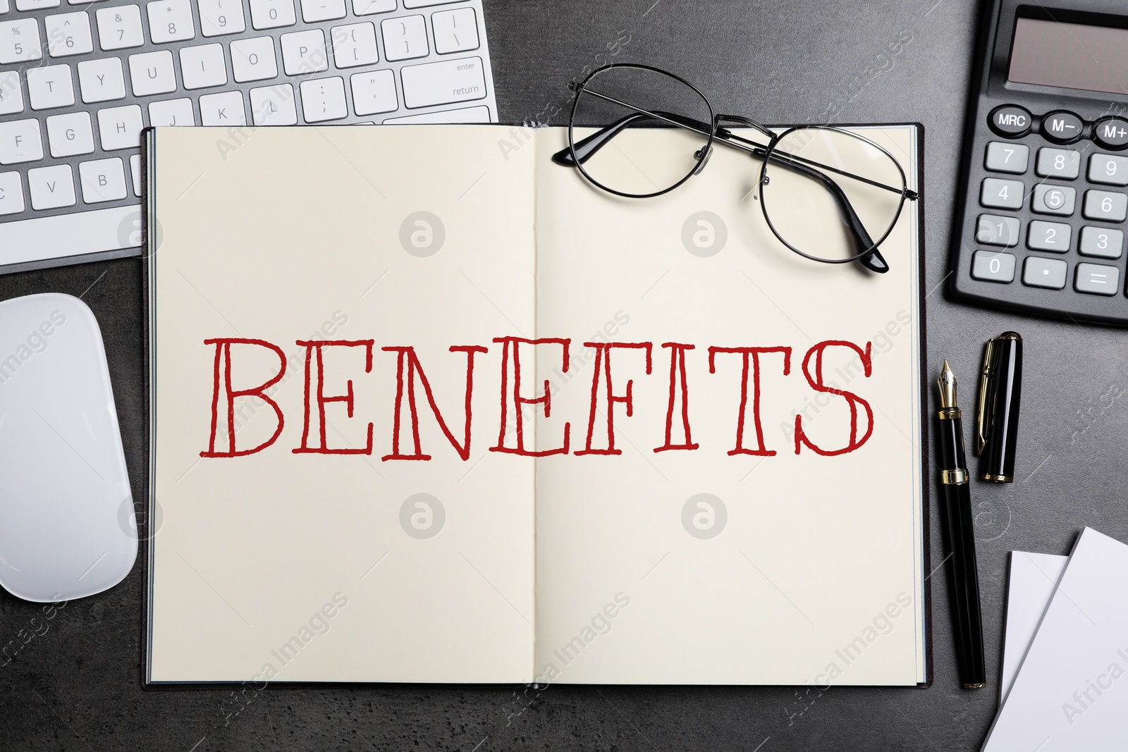 Image of Benefits word in notebook, calculator, eyeglasses, pen, computer keyboard and mouse on black table, top view