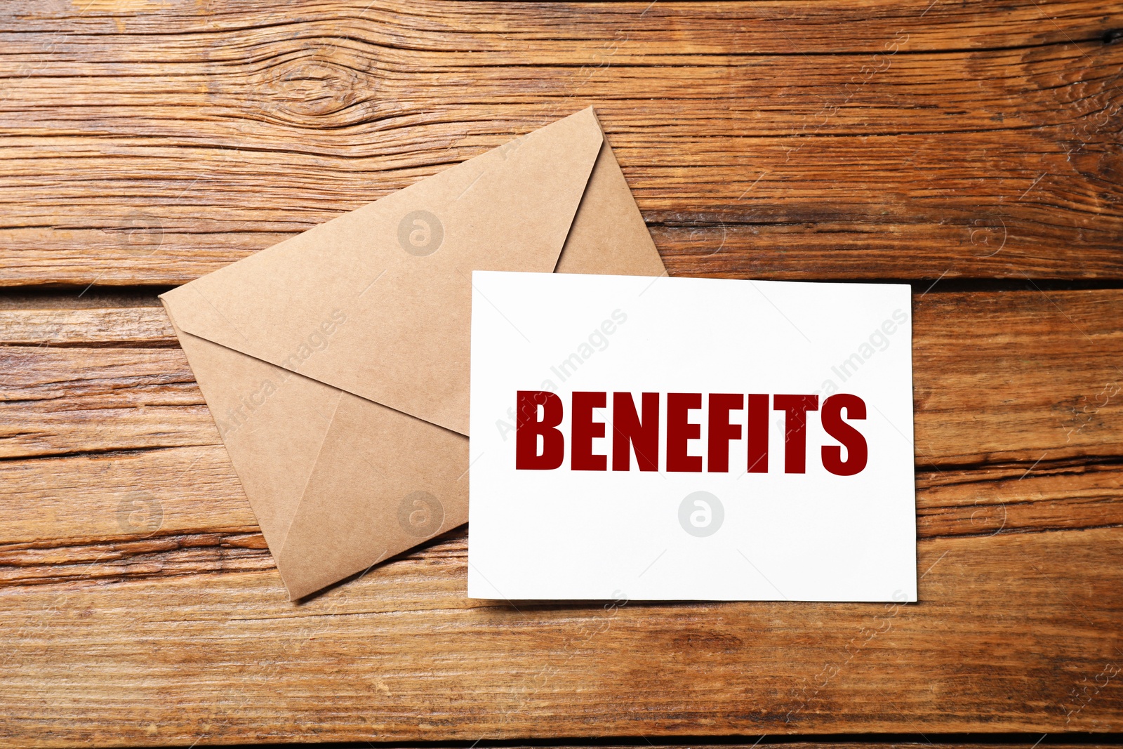 Image of Letter with Benefits word and envelope on wooden table, top view