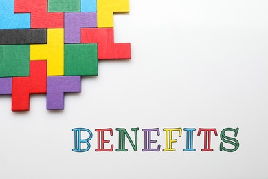 Image of Benefits word and wooden puzzle pieces on light background, top view