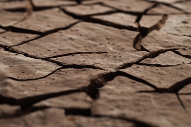 Photo of Dry cracked ground as background, closeup. Global warming