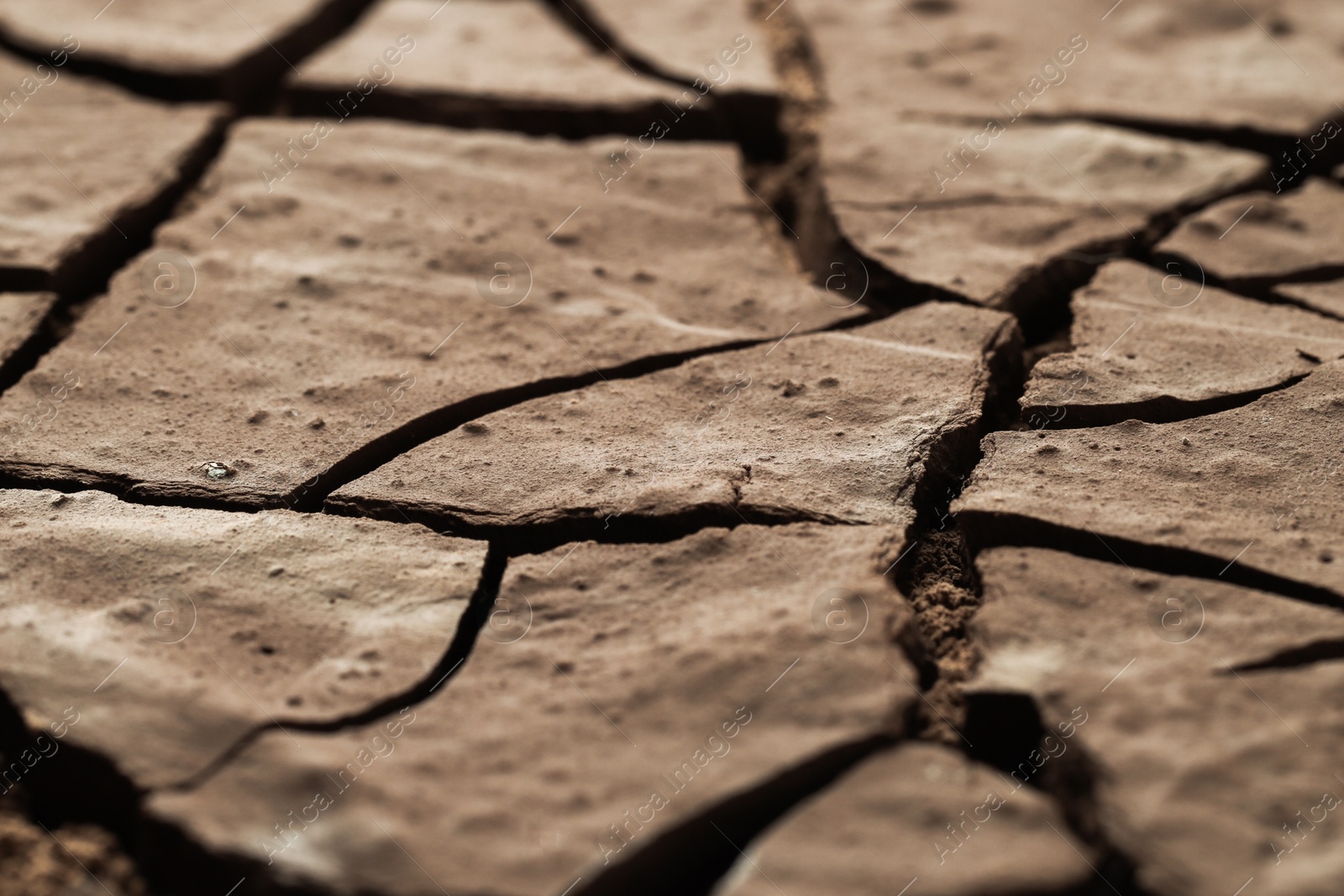 Photo of Dry cracked ground as background, closeup. Global warming