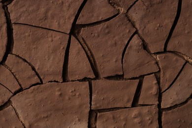 Photo of Dry cracked ground as background, closeup. Global warming