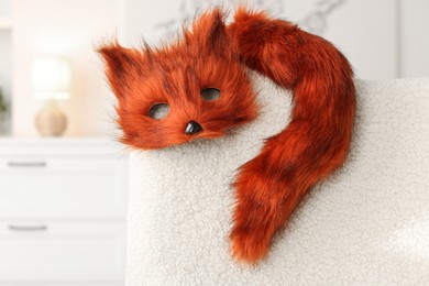 Quadrobics. Fox mask and tail on armchair indoors