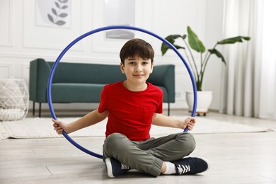 Photo of Boy with hula hoop on floor at home