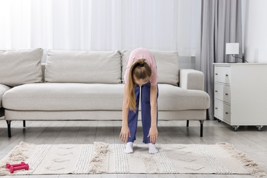 Photo of Little girl exercising at home, space for text. Morning routine