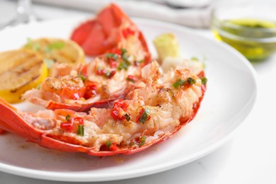 Photo of Delicious lobster tails with green onion on white table, closeup