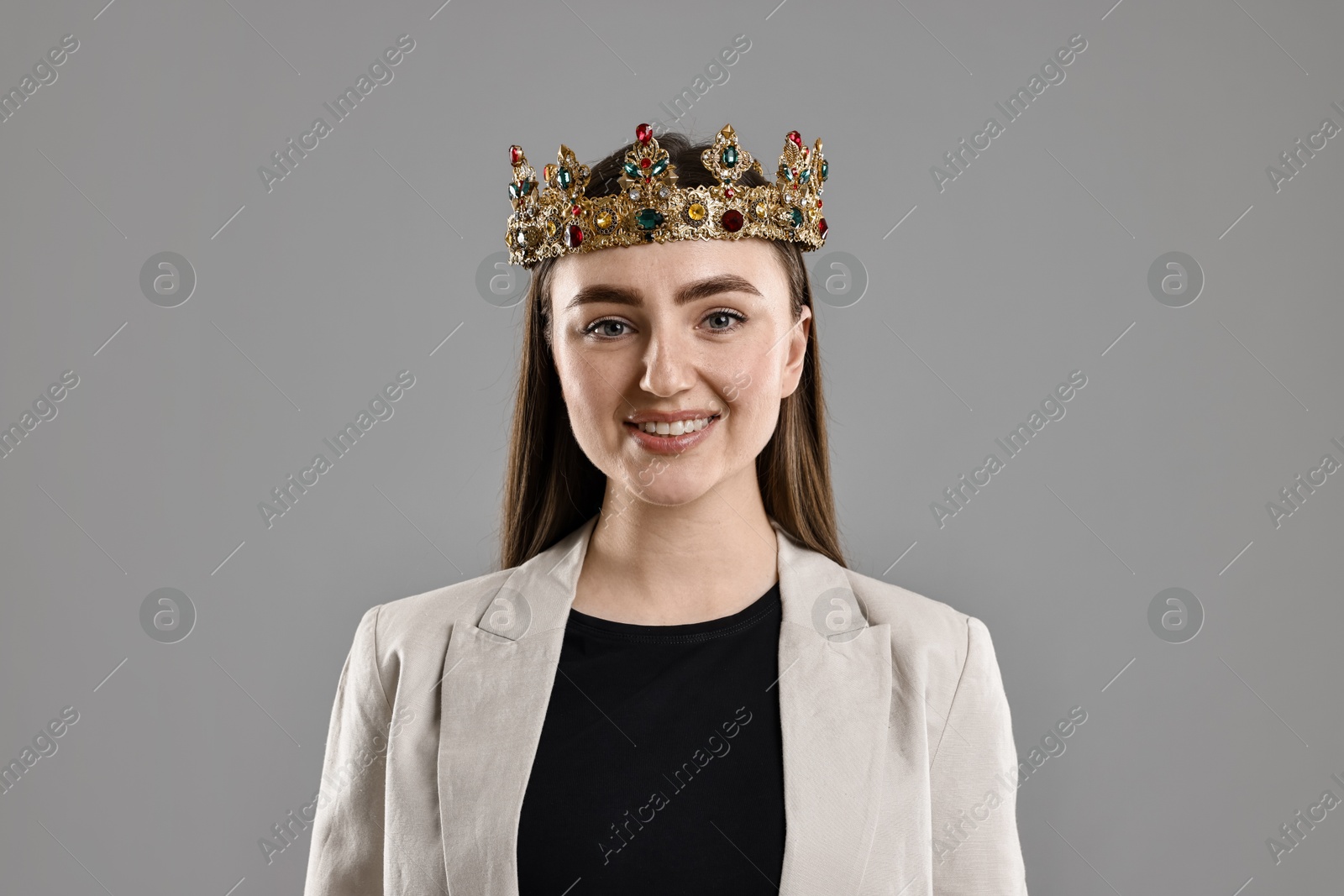 Photo of Happy businesswoman in elegant crown on grey background