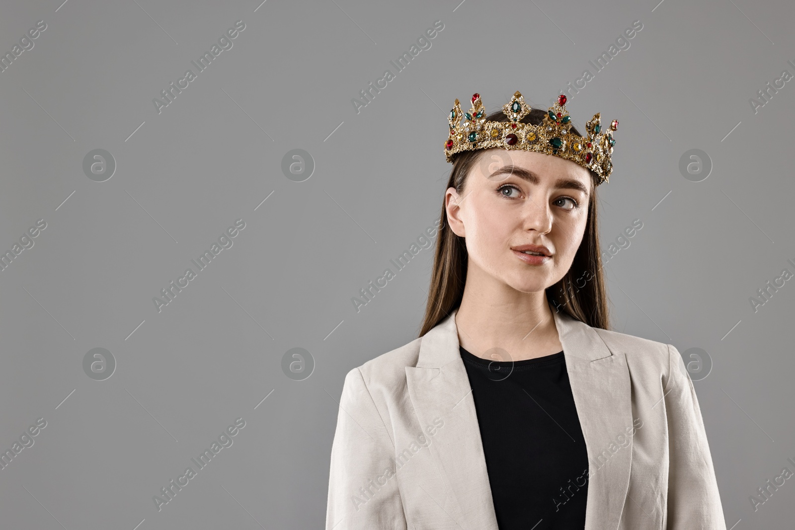 Photo of Businesswoman in elegant crown on grey background. Space for text