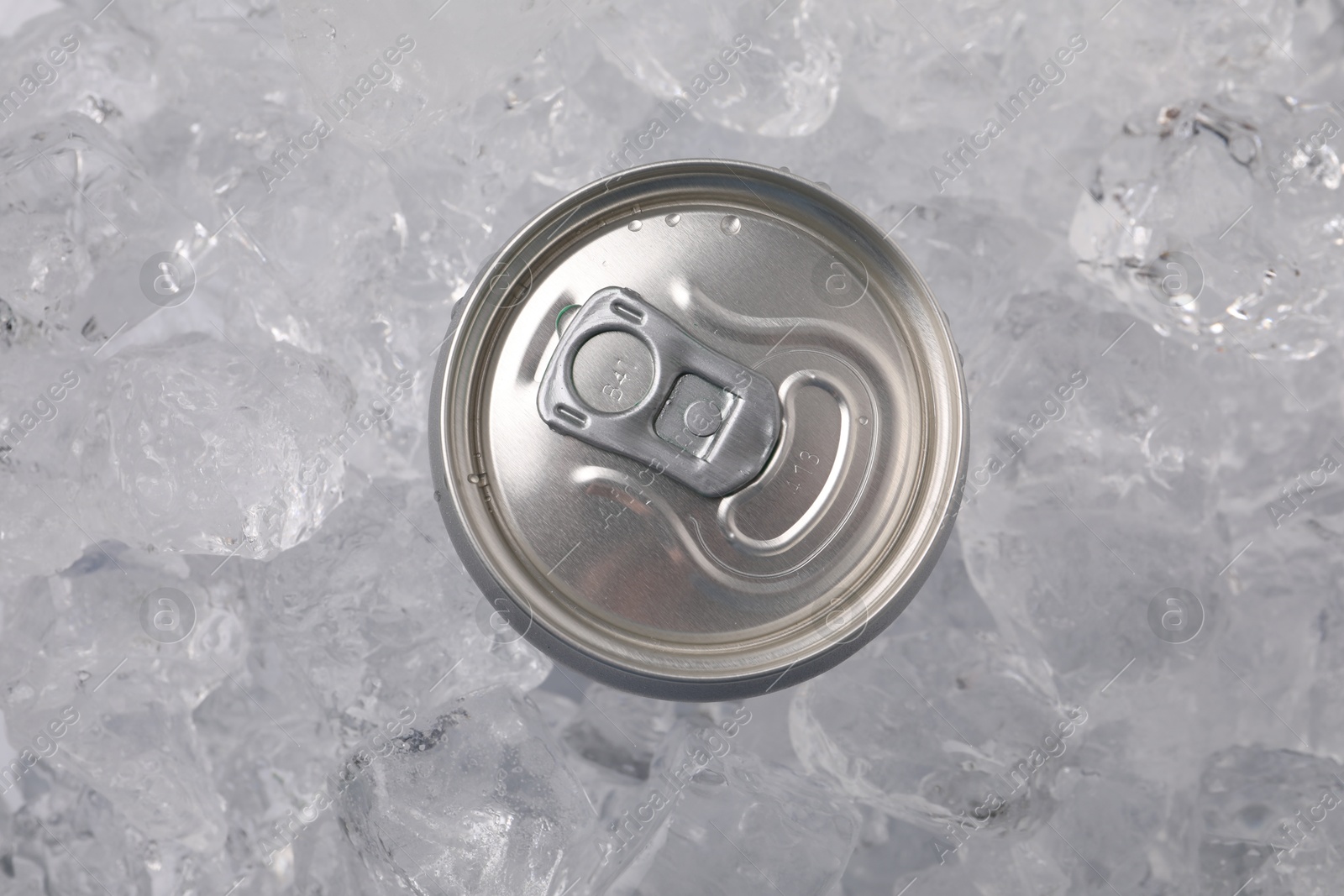 Refreshing drink in can on ice cubes, top view Photo of Refreshing drink in can on ice cubes, top view