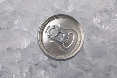 Photo of Refreshing drink in can on ice cubes, top view
