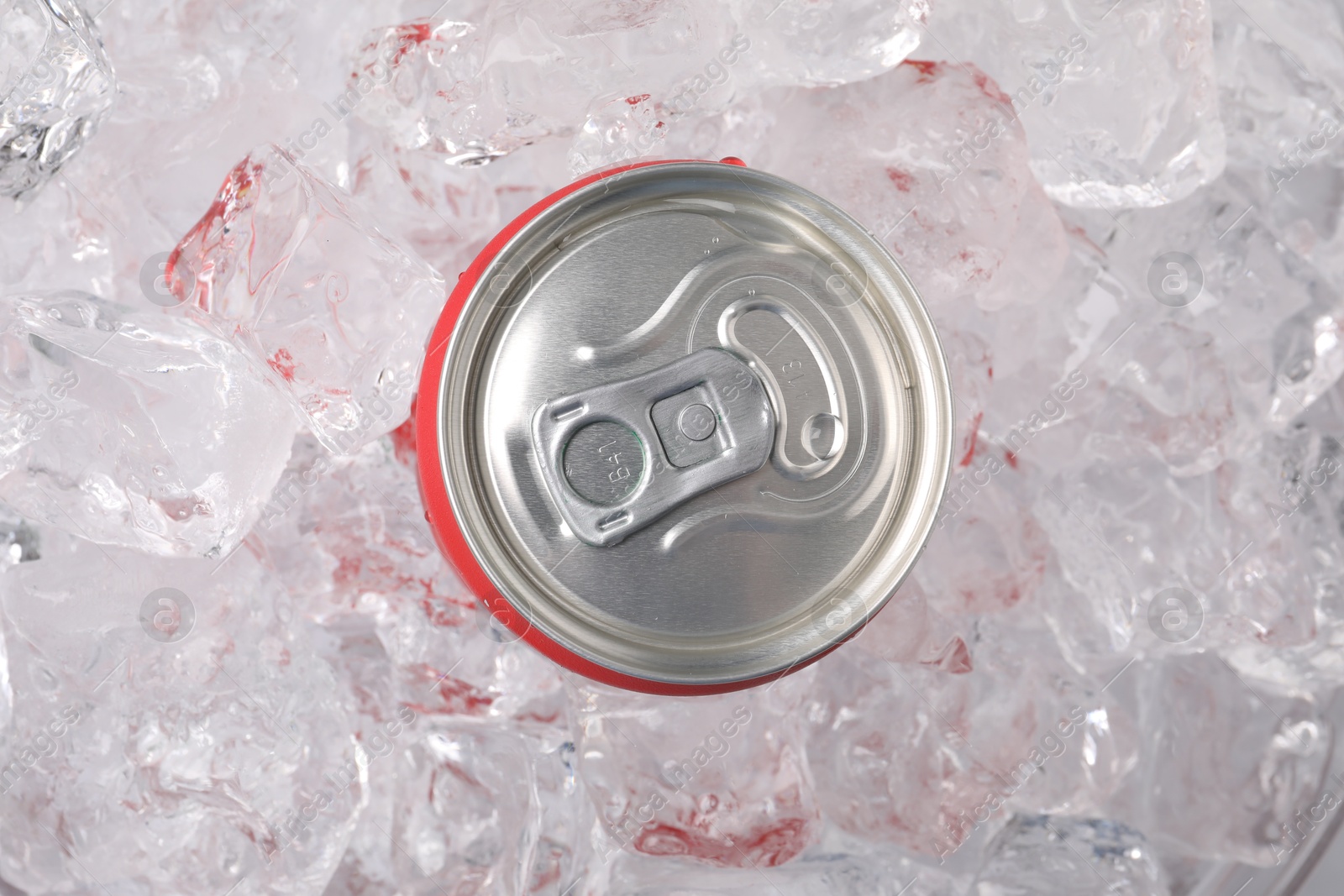 Refreshing drink in can on ice cubes, top view Photo of Refreshing drink in can on ice cubes, top view