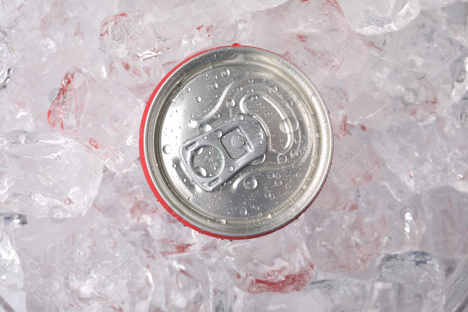 Refreshing drink in can on ice cubes, top view Photo of Refreshing drink in can on ice cubes, top view