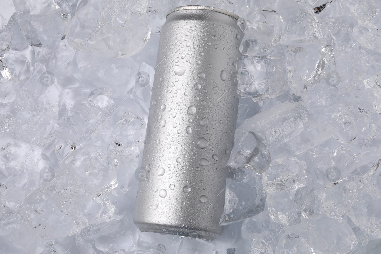 Refreshing drink in can on ice cubes, top view Photo of Refreshing drink in can on ice cubes, top view