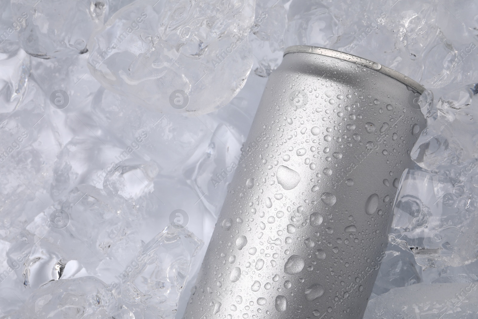 Refreshing drink in can on ice cubes, top view Photo of Refreshing drink in can on ice cubes, top view