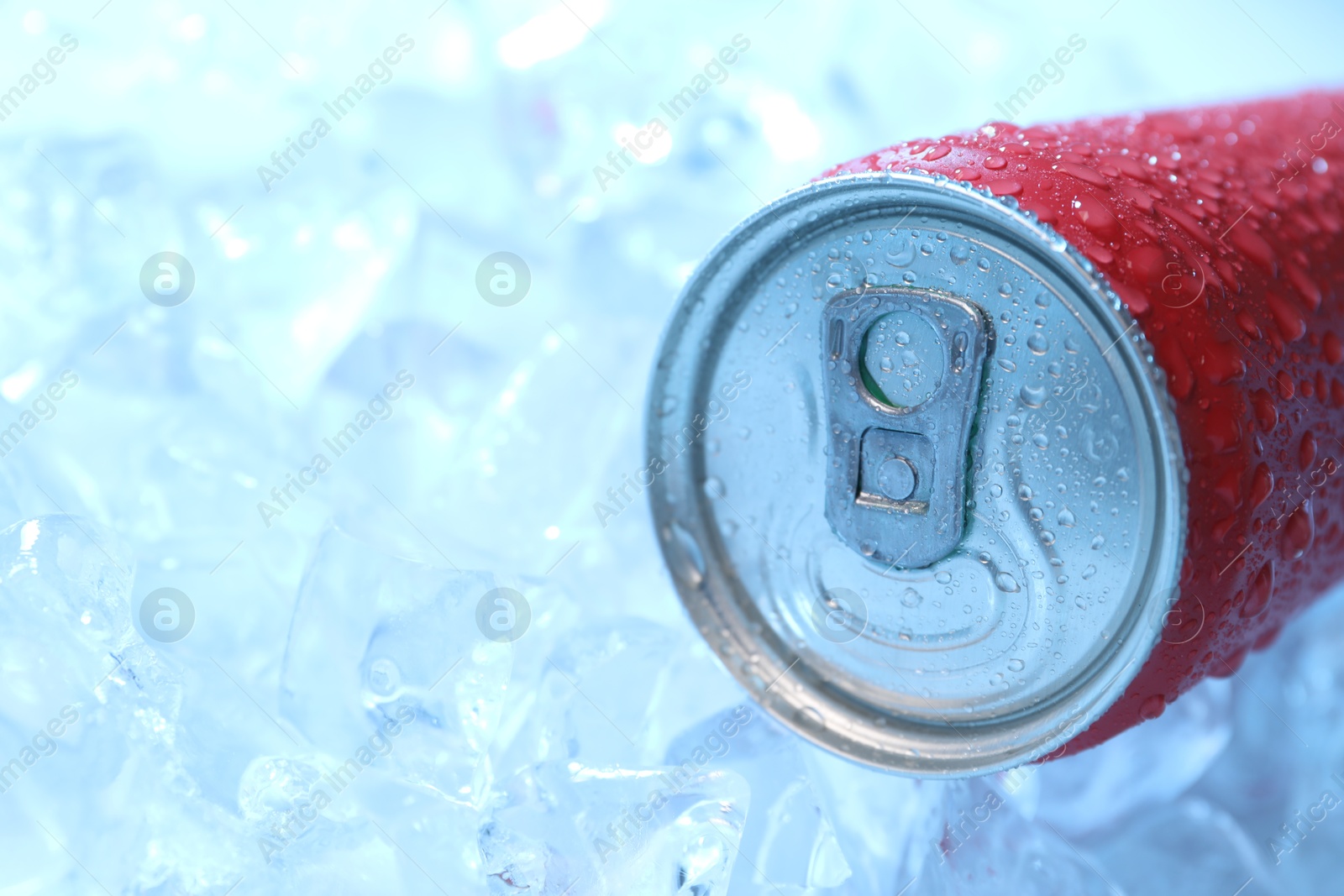 Refreshing drink in can on ice cubes, closeup. Space for text Photo of Refreshing drink in can on ice cubes, closeup. Space for text