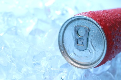 Photo of Refreshing drink in can on ice cubes, closeup. Space for text