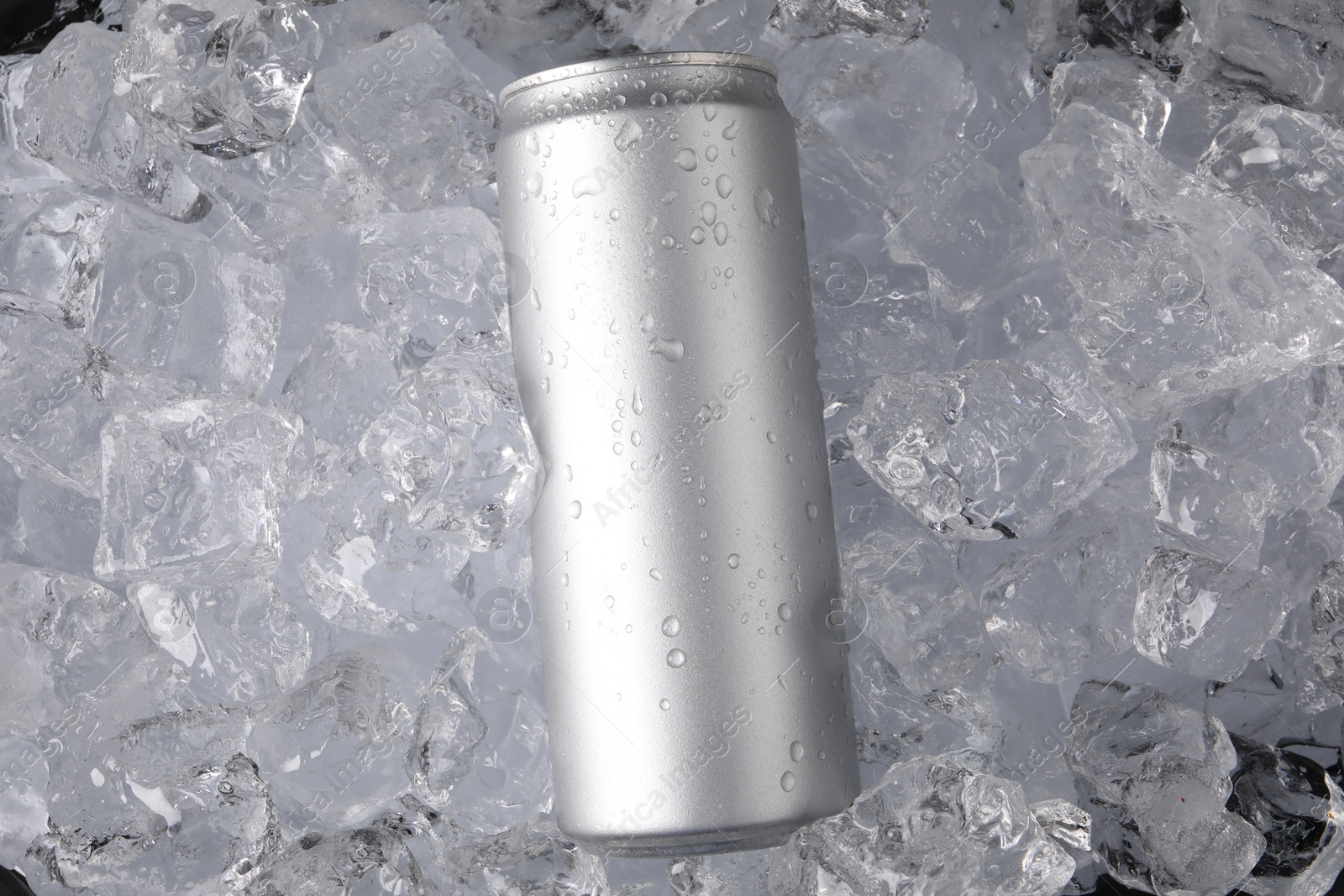 Refreshing drink in can on ice cubes, top view Photo of Refreshing drink in can on ice cubes, top view
